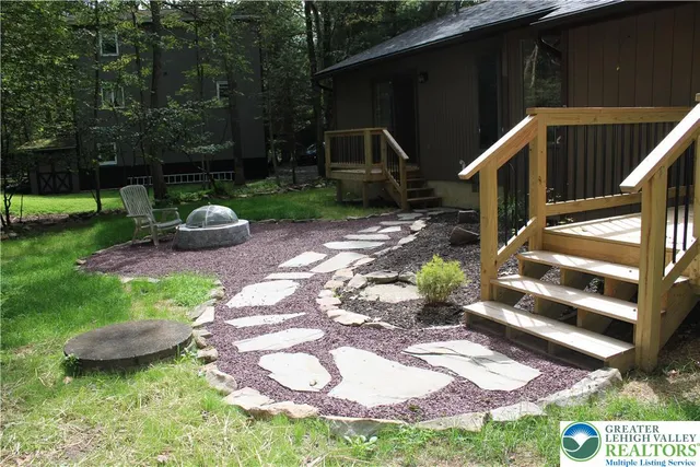 a view of a backyard with sitting area