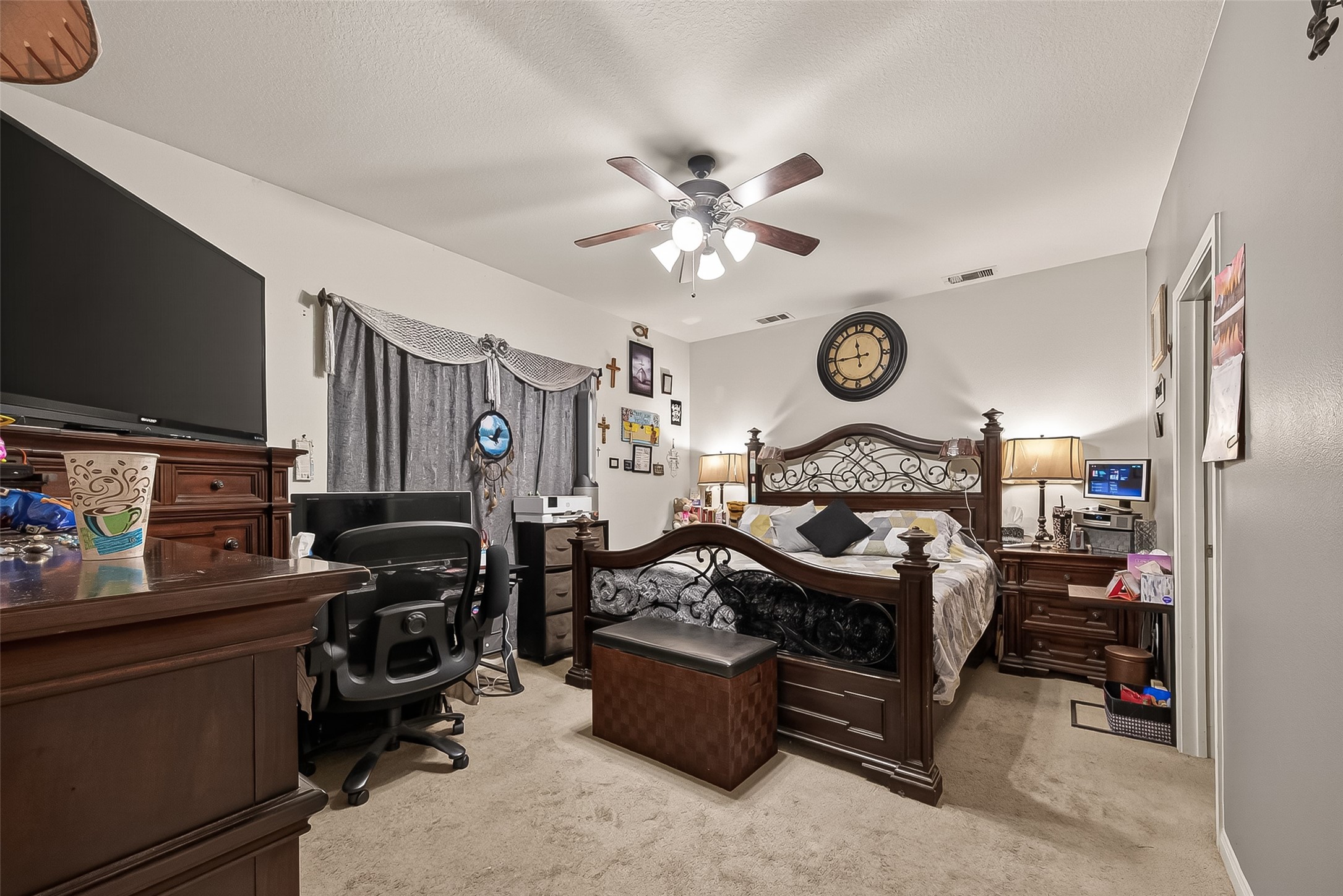 1019 Arnica Street Baytown, TX 77521 - Photo 11 of 16 a living room with furniture a flat screen tv and a clock