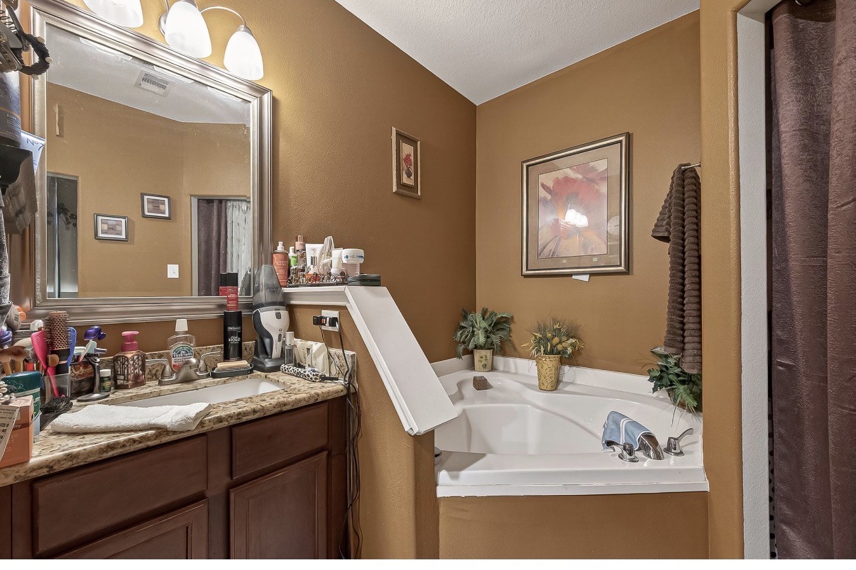 1019 Arnica Street Baytown, TX 77521 - Photo 12 of 16 a bathroom with a sink and a mirror