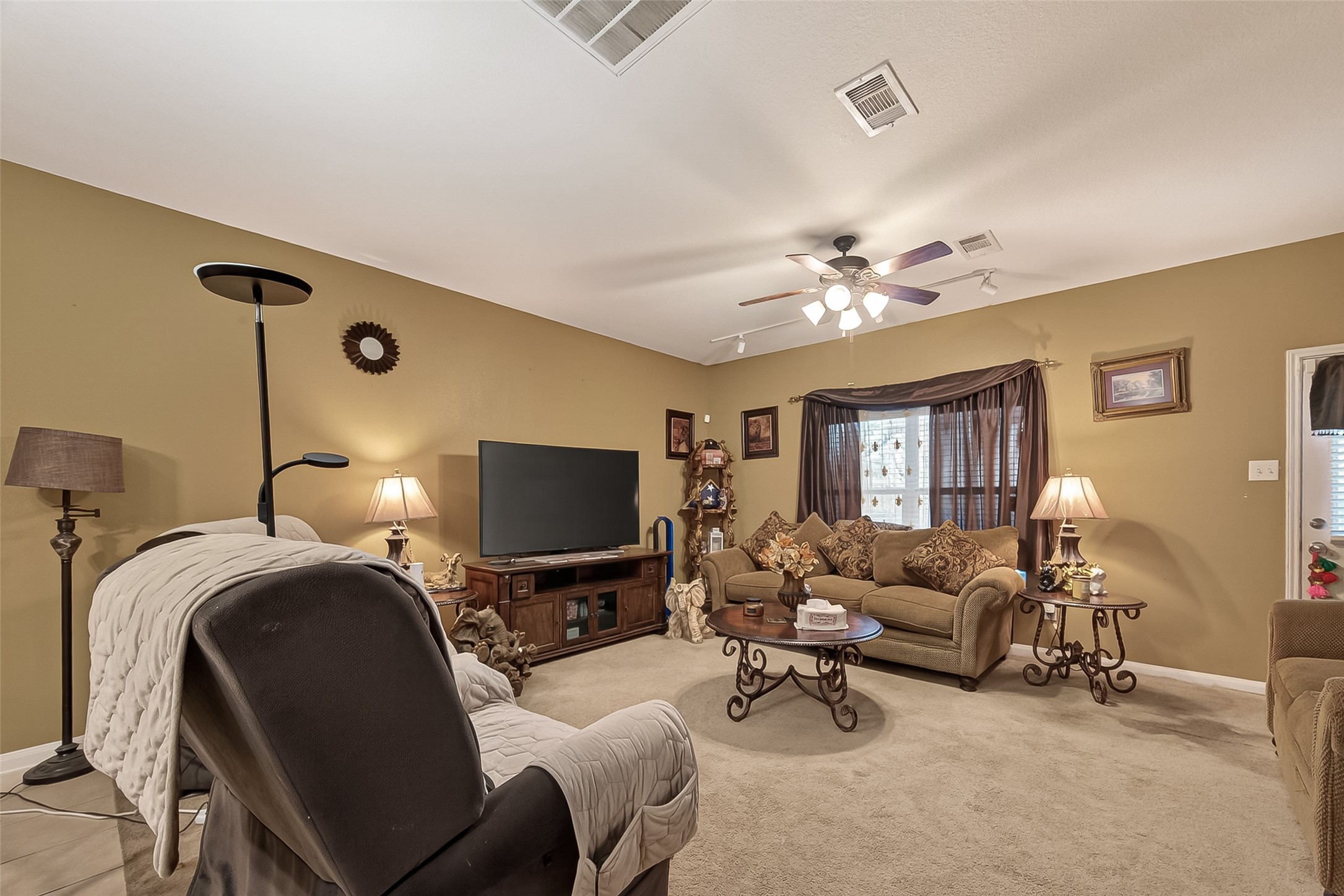 1019 Arnica Street Baytown, TX 77521 - Photo 5 of 16 a living room with furniture and a flat screen tv