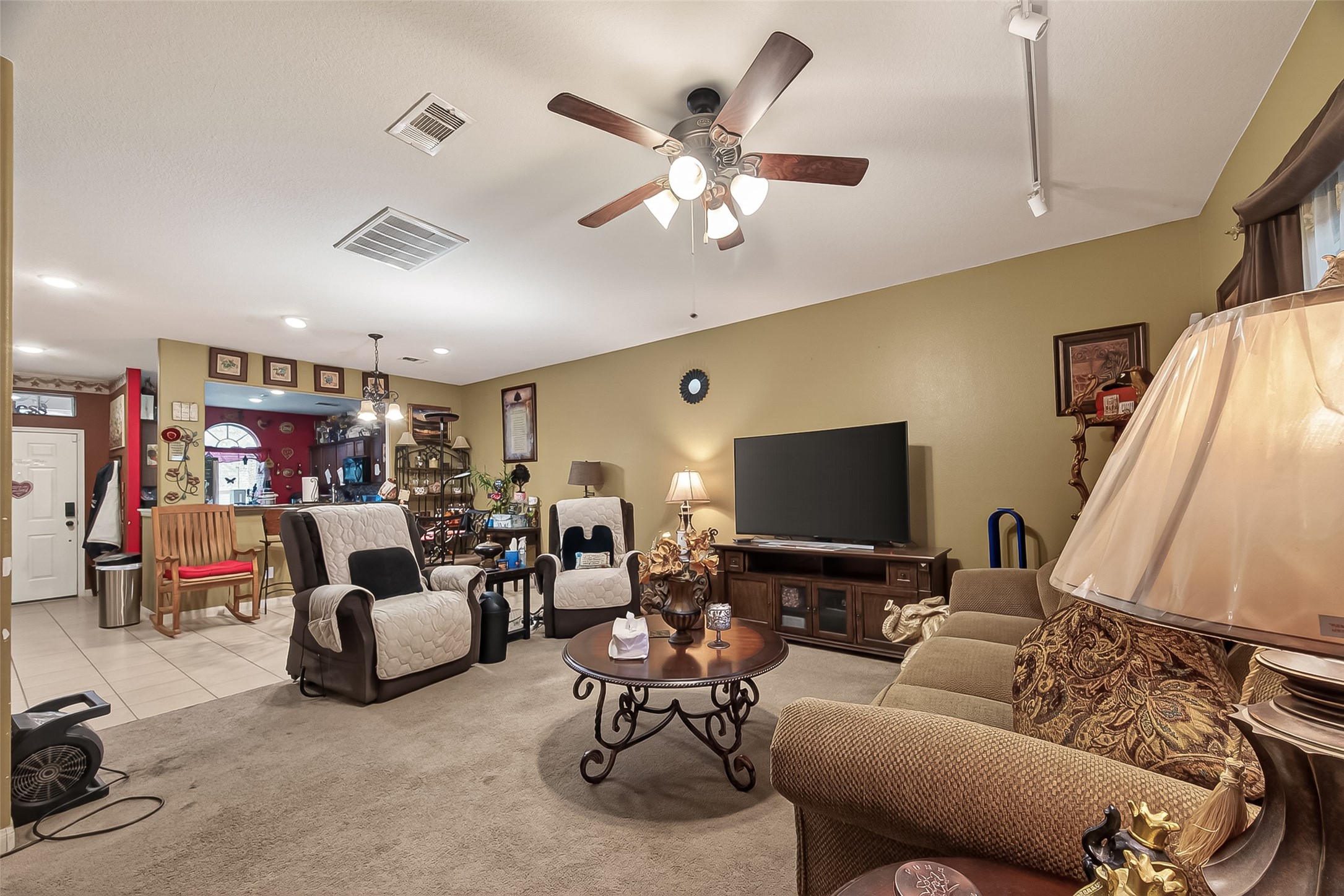 1019 Arnica Street Baytown, TX 77521 - Photo 7 of 16 a living room with furniture and a flat screen tv