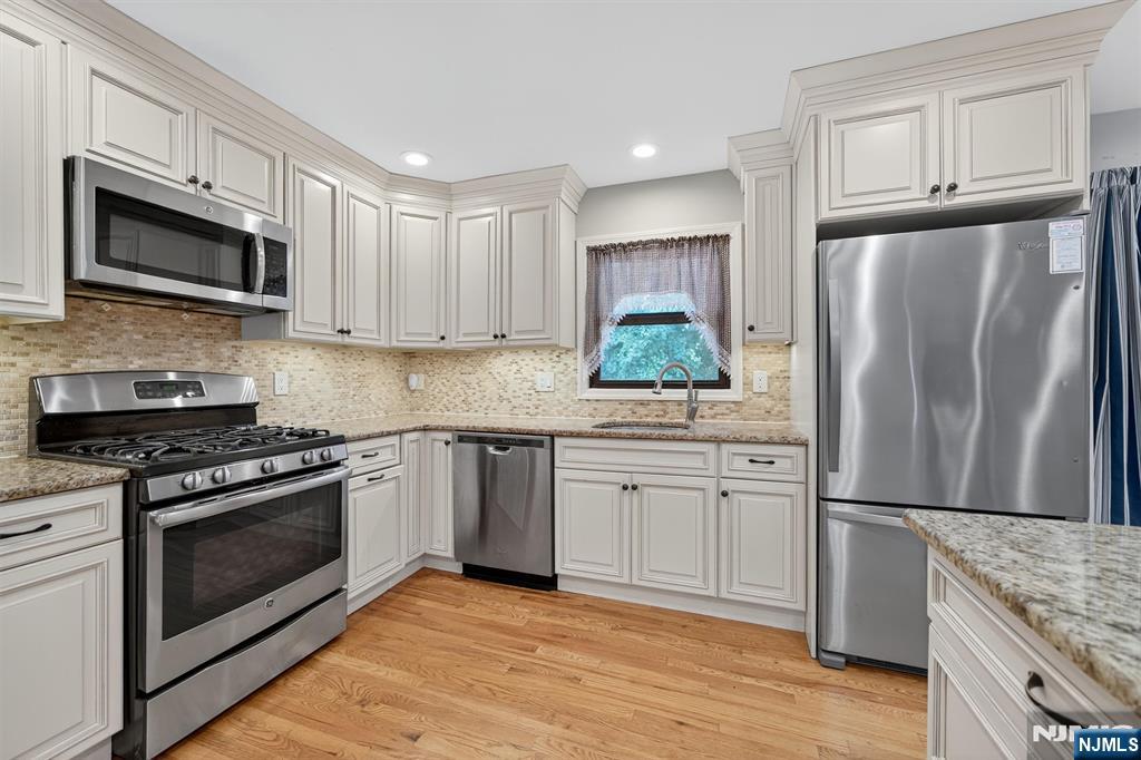 7 Faber Place Nutley, NJ 07110 - Photo 12 of 41 a kitchen with stainless steel appliances granite countertop a refrigerator stove and microwave