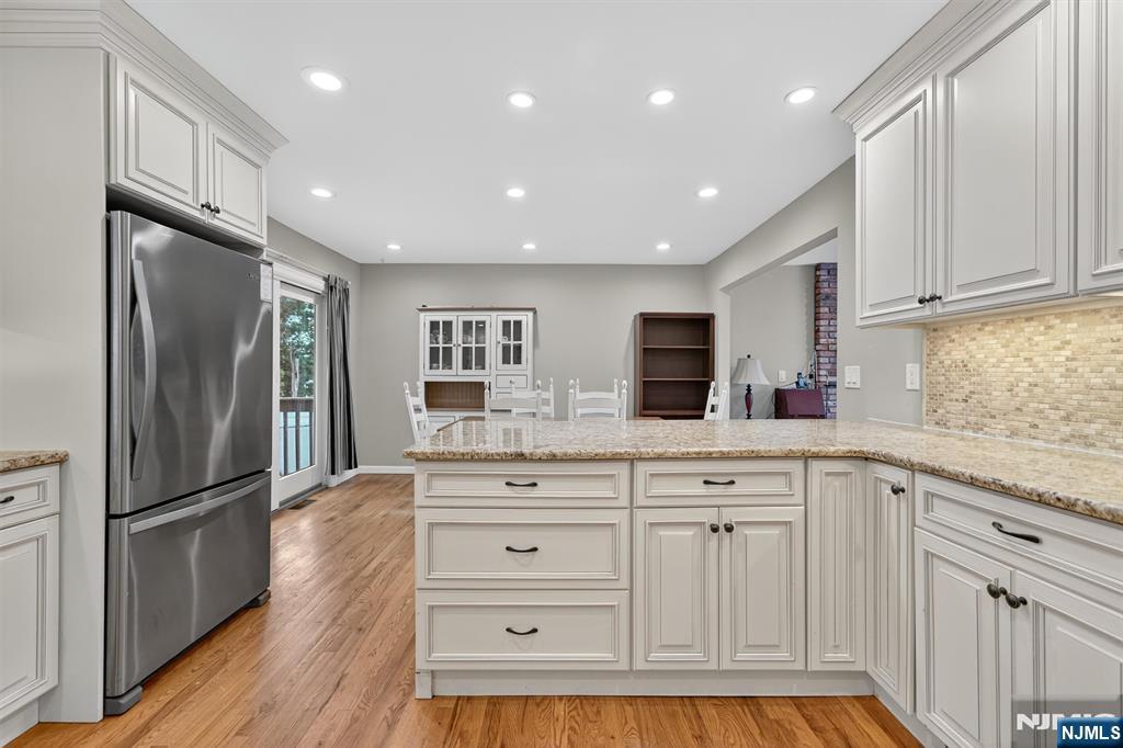 7 Faber Place Nutley, NJ 07110 - Photo 13 of 41 a kitchen with white cabinets and stainless steel appliances