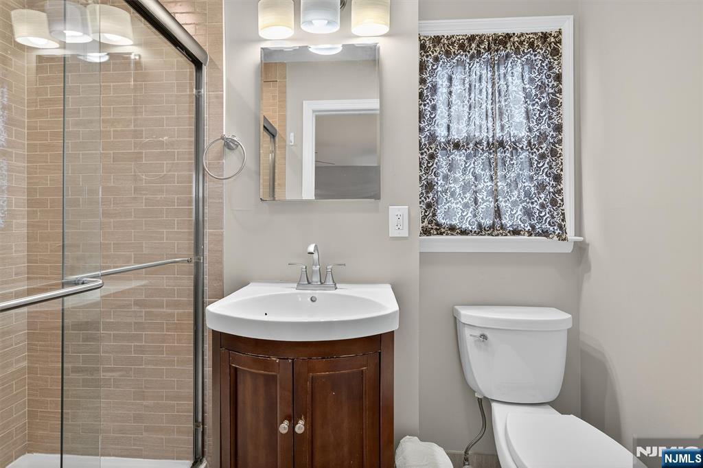 7 Faber Place Nutley, NJ 07110 - Photo 18 of 41 a bathroom with a toilet sink and mirror