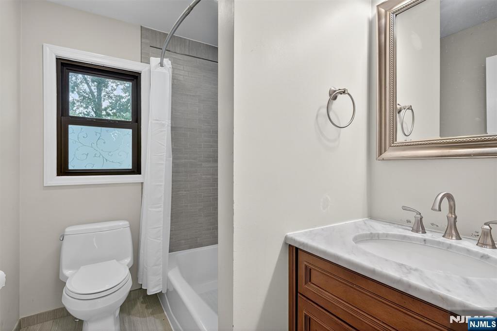 7 Faber Place Nutley, NJ 07110 - Photo 21 of 41 a bathroom with a toilet sink and mirror