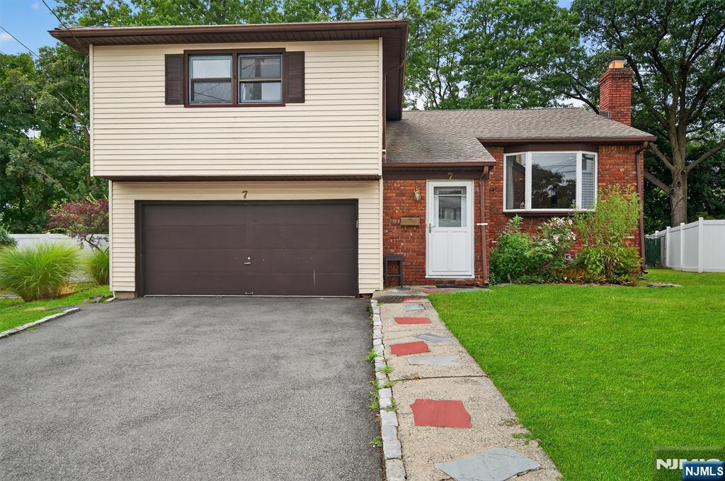7 Faber Place Nutley, NJ 07110 - Photo 38 of 41 a front view of a house with a yard and garage