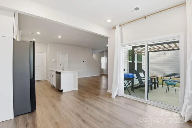 a view of kitchen with furniture and a refrigerator