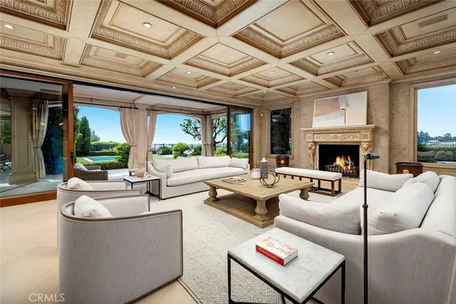 a living room with fireplace furniture and a large window
