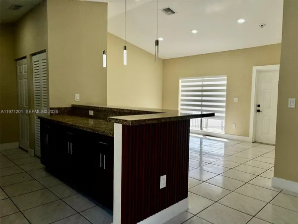 a kitchen with stainless steel appliances granite countertop a refrigerator and a stove