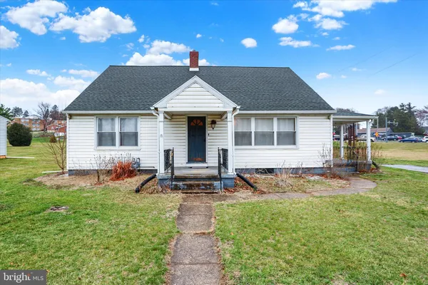 a front view of a house with patio and garden
