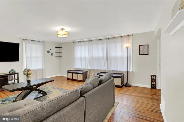 a living room with furniture and flat screen tv