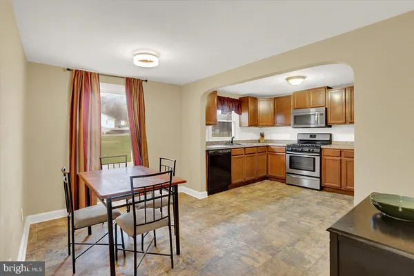 a kitchen with stainless steel appliances granite countertop a stove a sink a microwave and a refrigerator