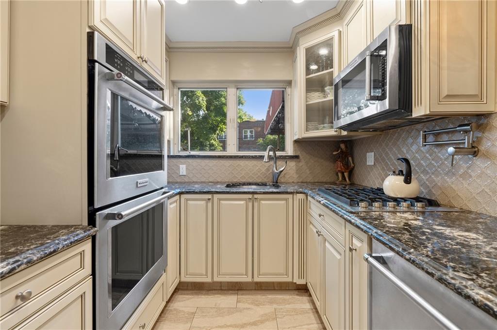 2472 Stuart Street Brooklyn, NY 11229 - Photo 11 of 28 a kitchen with stainless steel appliances granite countertop a stove and a sink