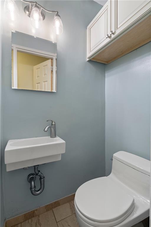 2472 Stuart Street Brooklyn, NY 11229 - Photo 12 of 28 a bathroom with a sink a toilet and mirror