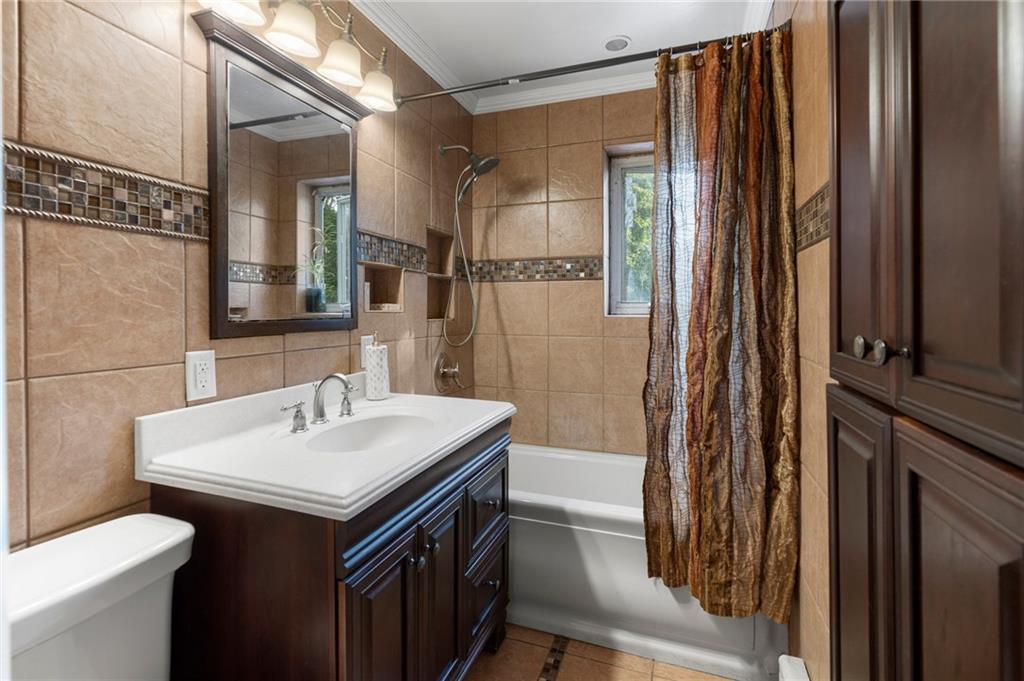 2472 Stuart Street Brooklyn, NY 11229 - Photo 19 of 28 a bathroom with a sink and a mirror