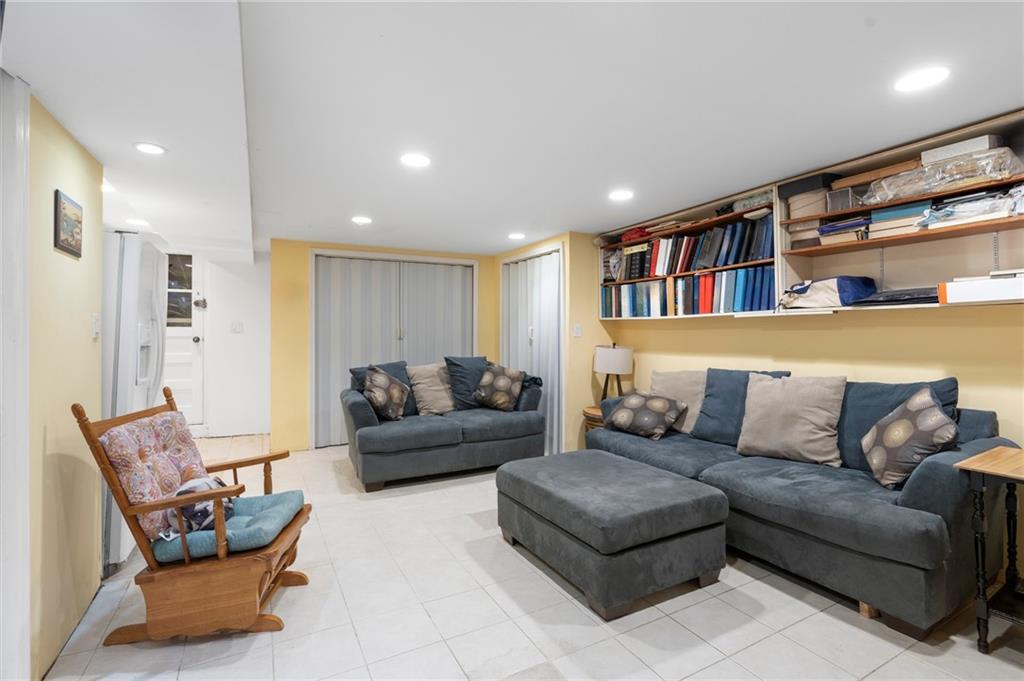2472 Stuart Street Brooklyn, NY 11229 - Photo 21 of 28 a living room with furniture and a book shelf