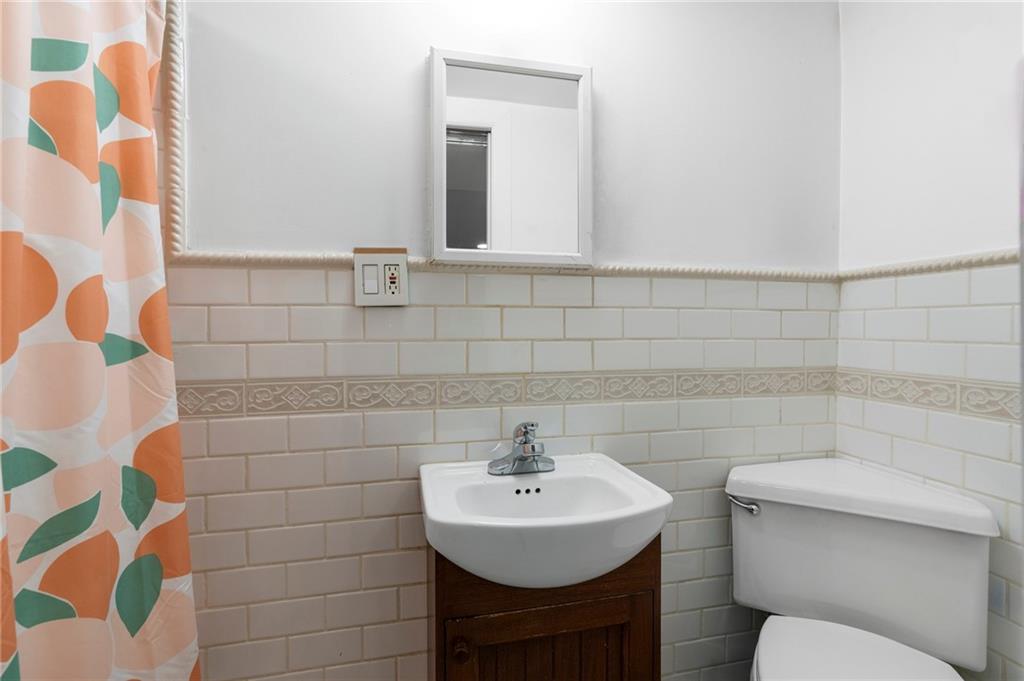 2472 Stuart Street Brooklyn, NY 11229 - Photo 23 of 28 a bathroom with a sink toilet and mirror