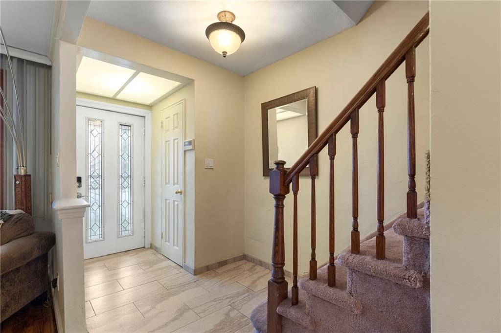 2472 Stuart Street Brooklyn, NY 11229 - Photo 3 of 28 a view of an entryway with wooden floor and stairs