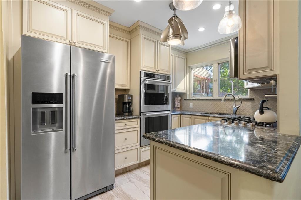 2472 Stuart Street Brooklyn, NY 11229 - Photo 10 of 28 a kitchen with stainless steel appliances granite countertop a refrigerator a stove and a sink