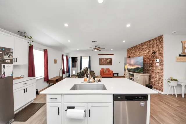 a kitchen with a sink a stove and cabinets
