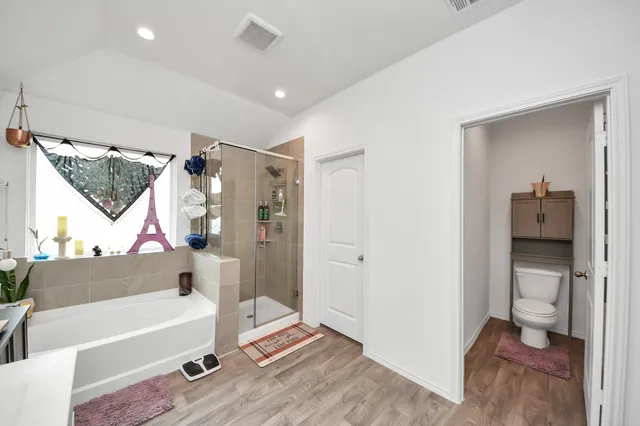 a bathroom with a tub and a shower