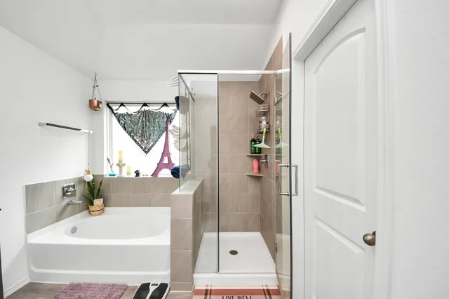 a bathroom with a tub and a shower