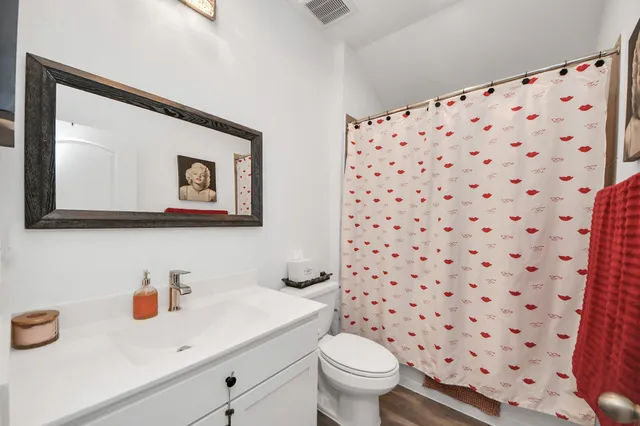 a bathroom with a sink toilet and a mirror