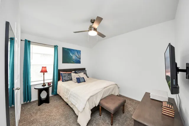 a bedroom with a bed and a chandelier