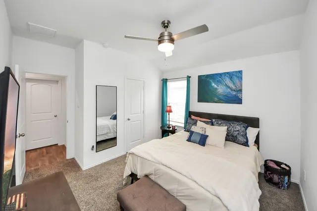 a bedroom with a bed and a tv