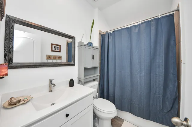 a bathroom with a sink a toilet and mirror