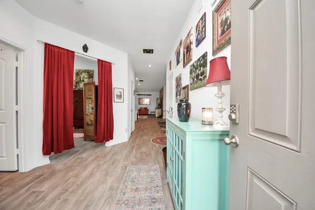 a hall way with furniture and a window