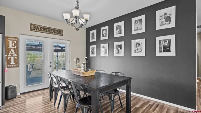 a view of a dining room with furniture and chandelier