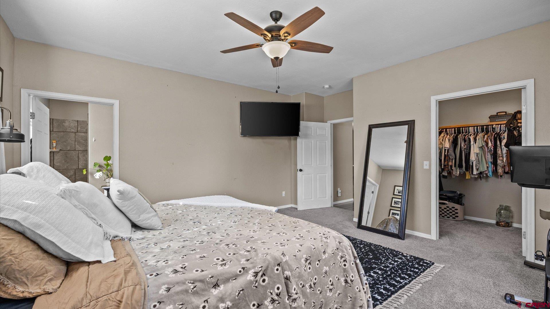 21017 Austin Road Austin, CO 81410 - Photo 14 of 29 a bedroom with a bed and a television
