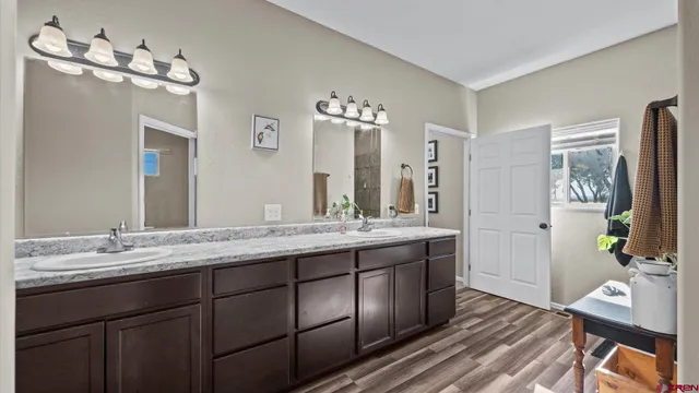 a bathroom with a double vanity sink and a mirror