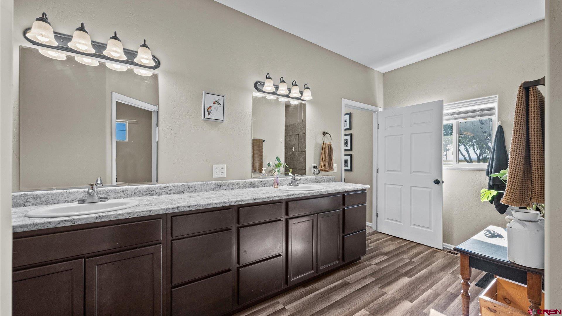 21017 Austin Road Austin, CO 81410 - Photo 16 of 29 a bathroom with a double vanity sink and a mirror
