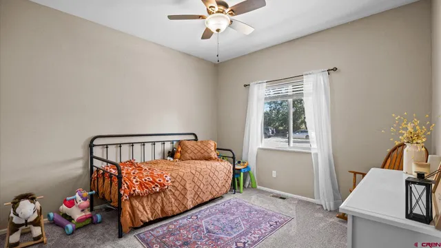 a bedroom with furniture and a window