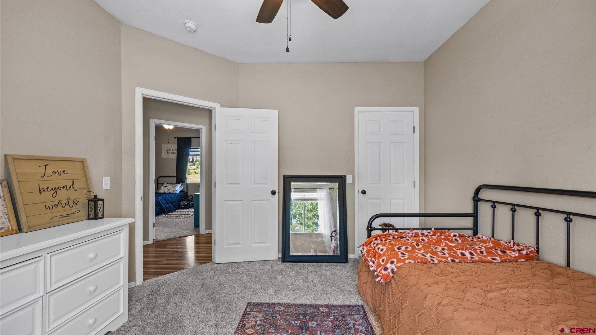 21017 Austin Road Austin, CO 81410 - Photo 20 of 29 a bedroom with a bed and a dresser