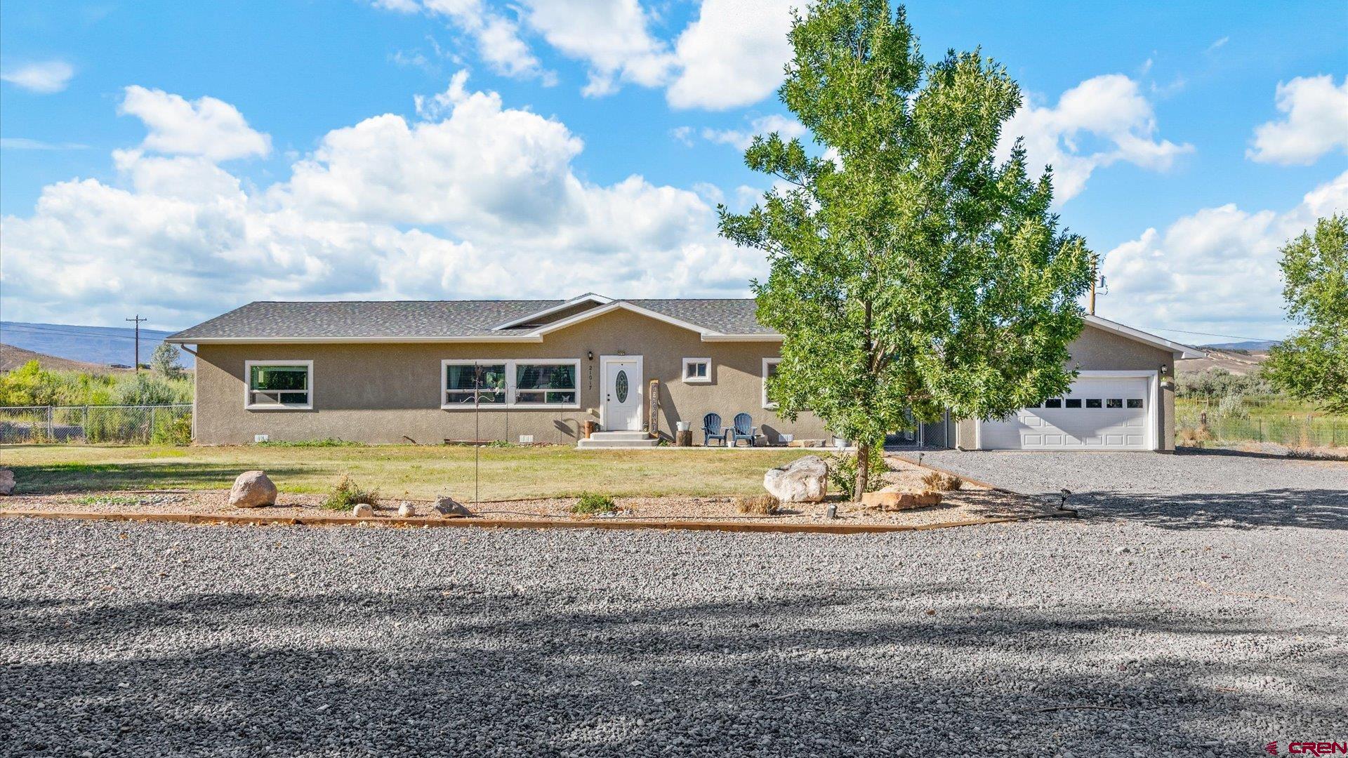 21017 Austin Road Austin, CO 81410 - Photo 2 of 29 a front view of house with yard and trees in the background