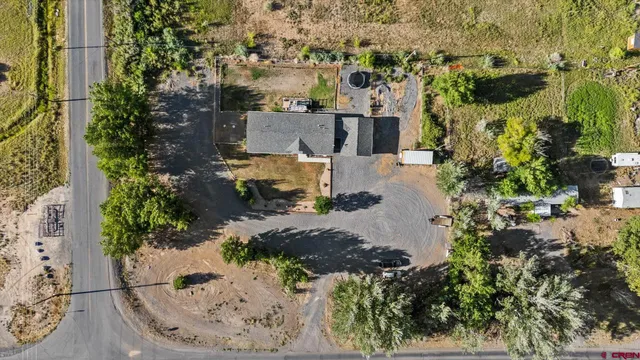 an aerial view of a house with a yard and lake view