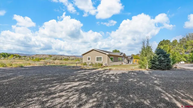 a view of front of a house with a big yard