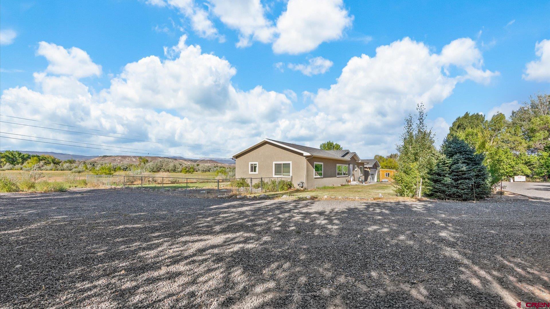 21017 Austin Road Austin, CO 81410 - Photo 3 of 29 a view of front of a house with a big yard