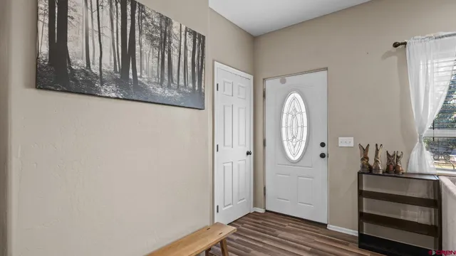 a view of front door with wooden floor