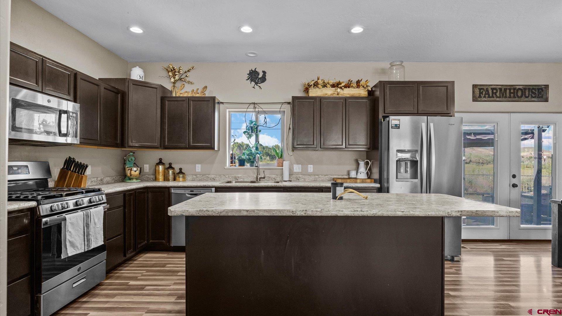 21017 Austin Road Austin, CO 81410 - Photo 10 of 29 a kitchen with stainless steel appliances granite countertop a sink a stove and a refrigerator