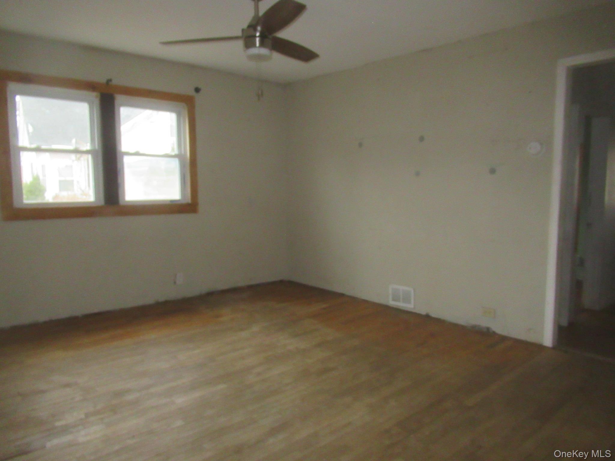 162 Osborne Hill Road Fishkill, NY 12524 - Photo 8 of 11 Empty room with wood finished floors and a ceiling fan