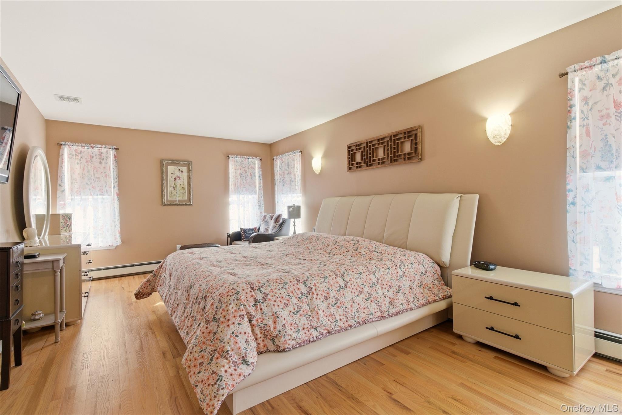 4 Macintosh Lane Selden, NY 11784 - Photo 10 of 30 a bedroom with a bed and wooden floor