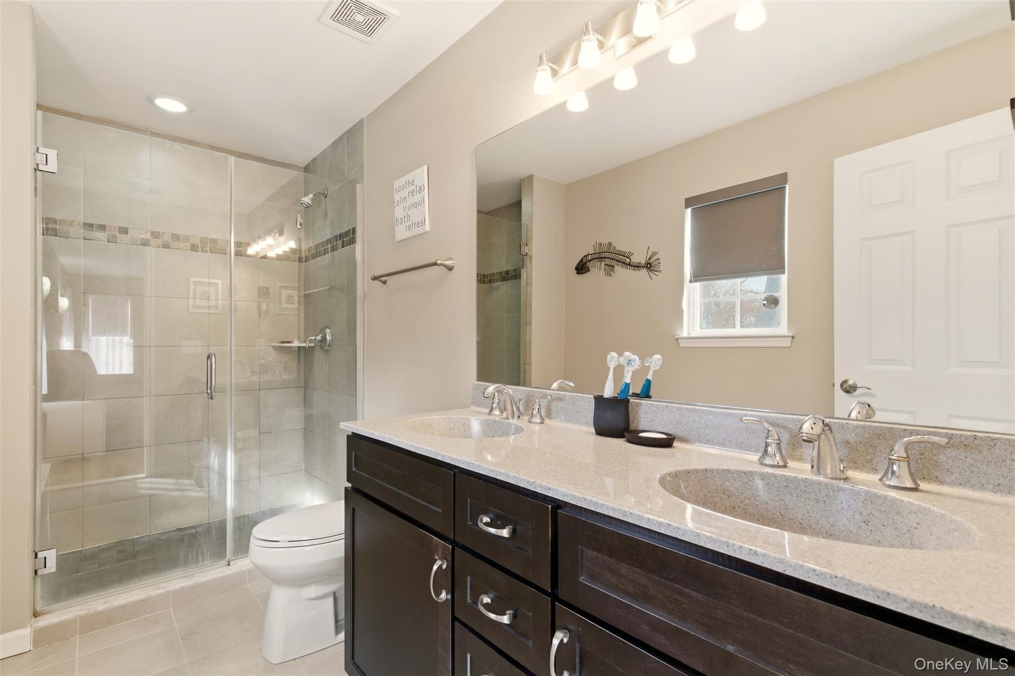 4 Macintosh Lane Selden, NY 11784 - Photo 12 of 30 a bathroom with a granite countertop sink toilet a large mirror a shower and vanity