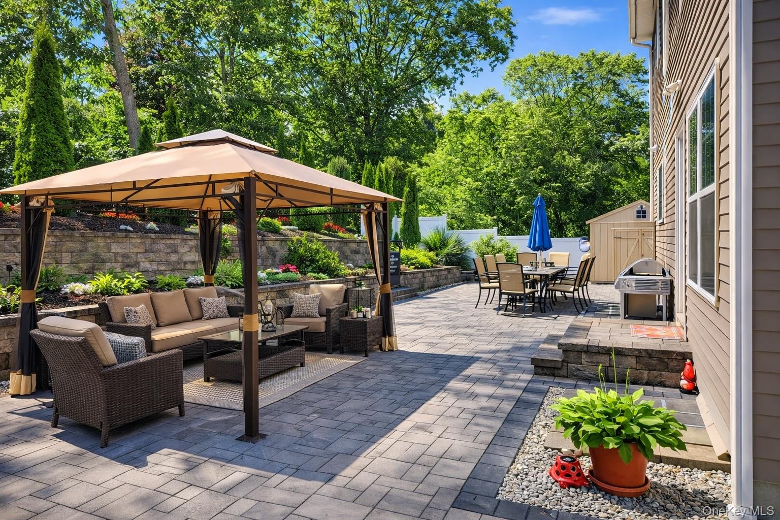 4 Macintosh Lane Selden, NY 11784 - Photo 18 of 30 a view of a patio with couches table and chairs potted plants and palm tree