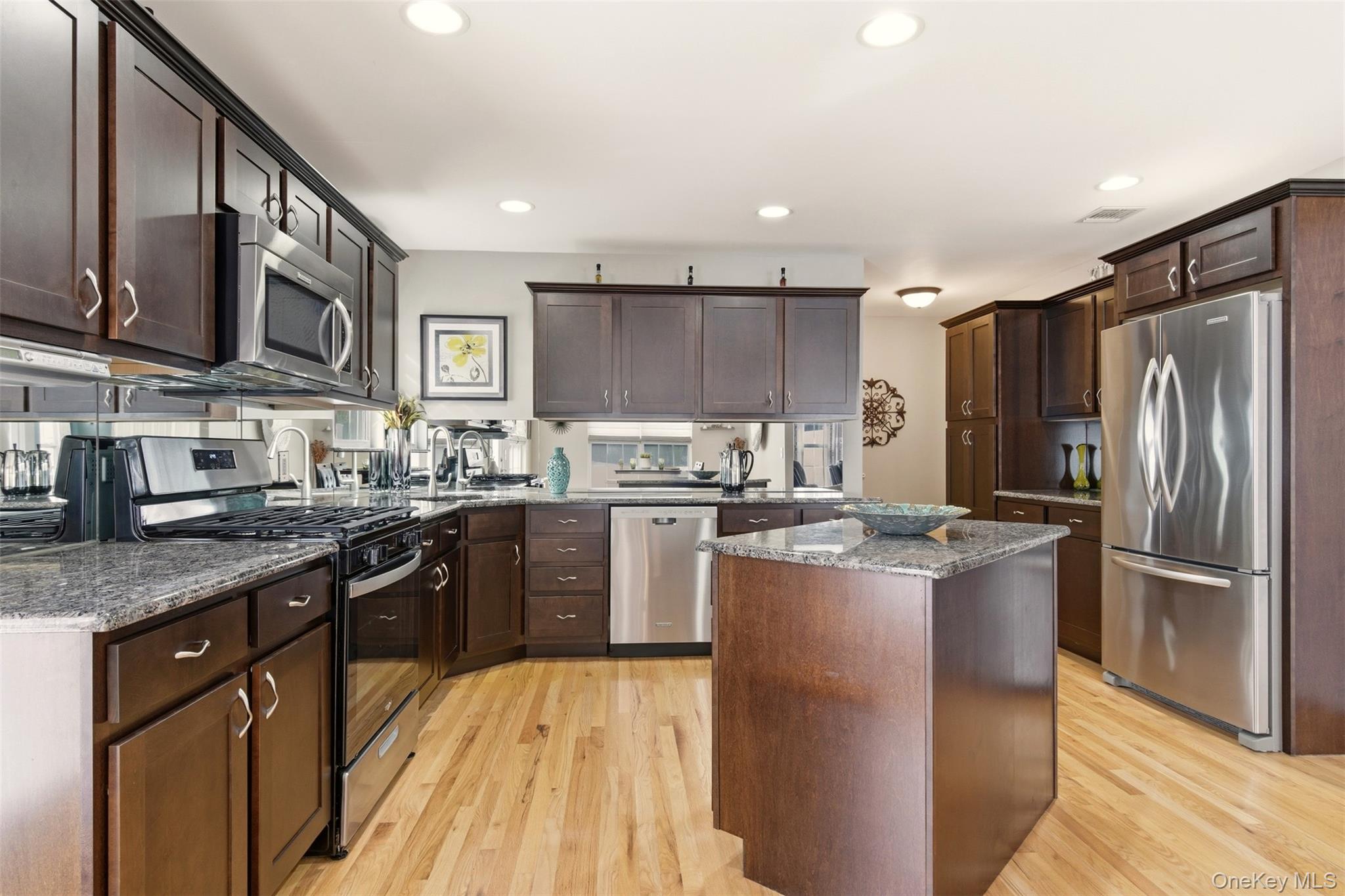 4 Macintosh Lane Selden, NY 11784 - Photo 3 of 30 a kitchen with stainless steel appliances granite countertop a refrigerator a stove top oven a sink and dishwasher