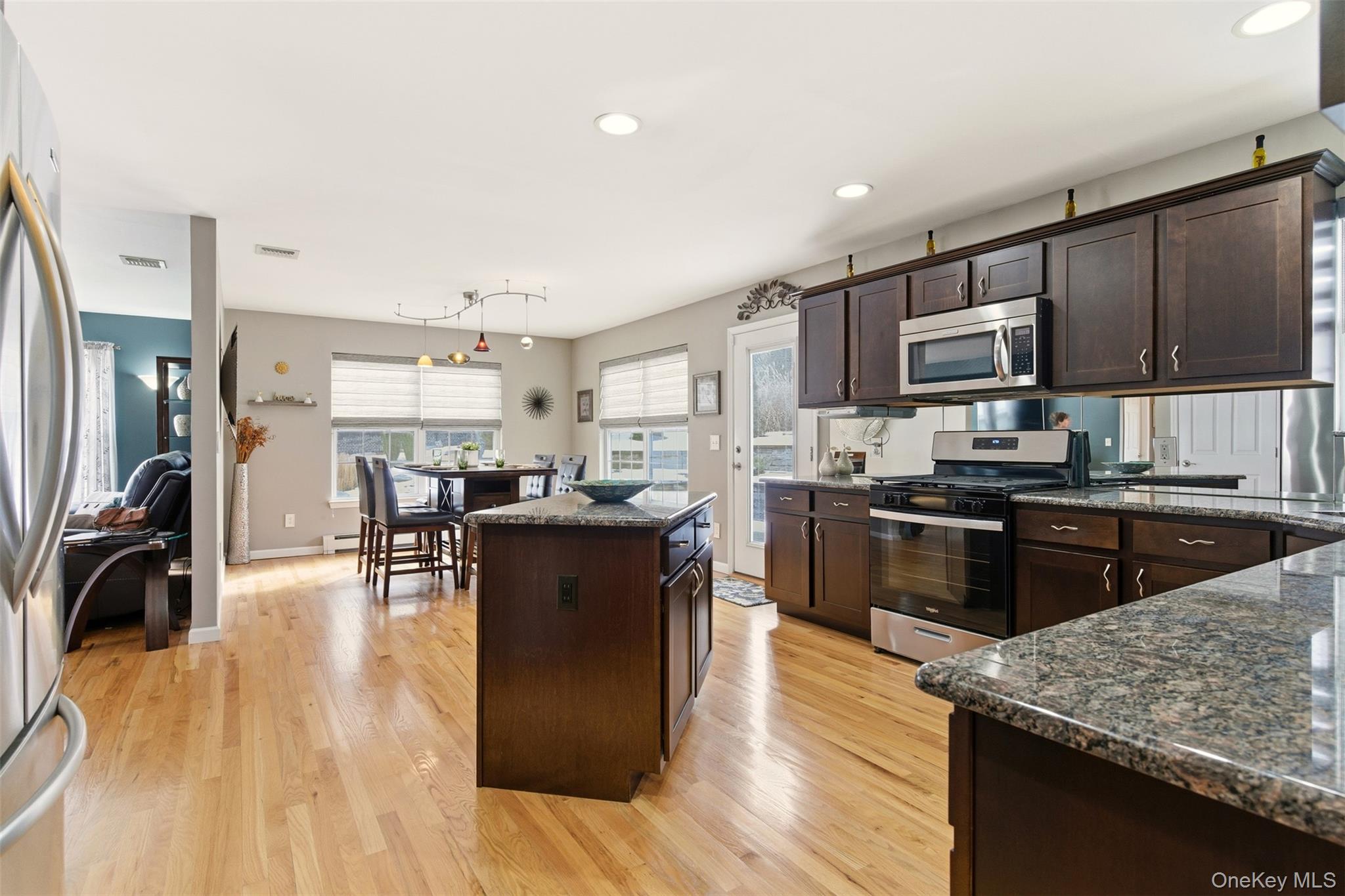 4 Macintosh Lane Selden, NY 11784 - Photo 4 of 30 a kitchen with stainless steel appliances granite countertop a refrigerator stove microwave and sink