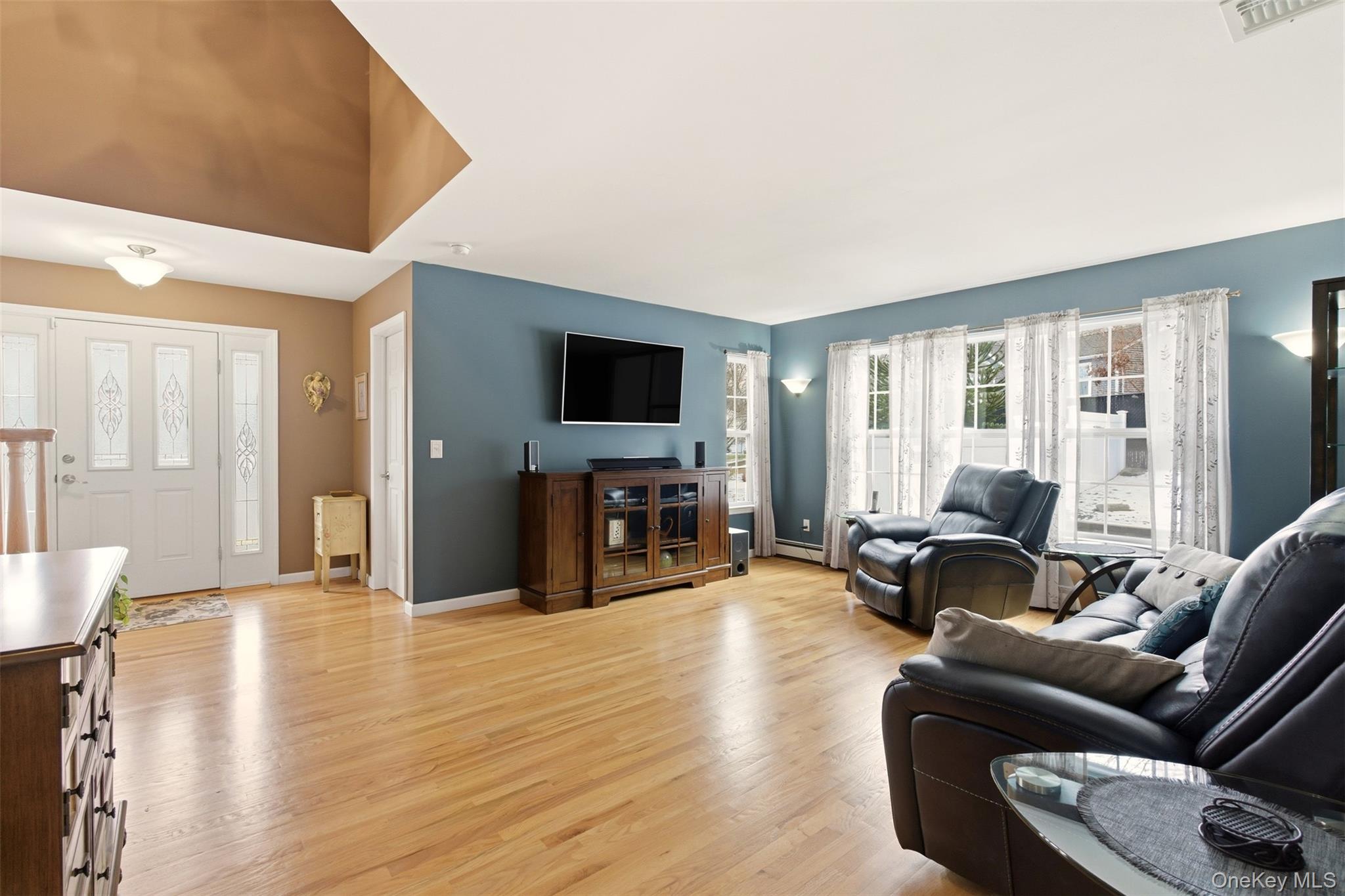 4 Macintosh Lane Selden, NY 11784 - Photo 27 of 30 a living room with furniture and a flat screen tv